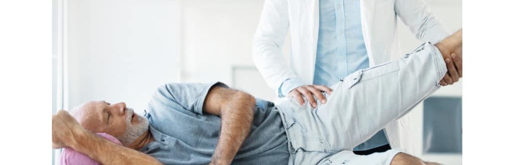 man with hip pain with a physical therapist