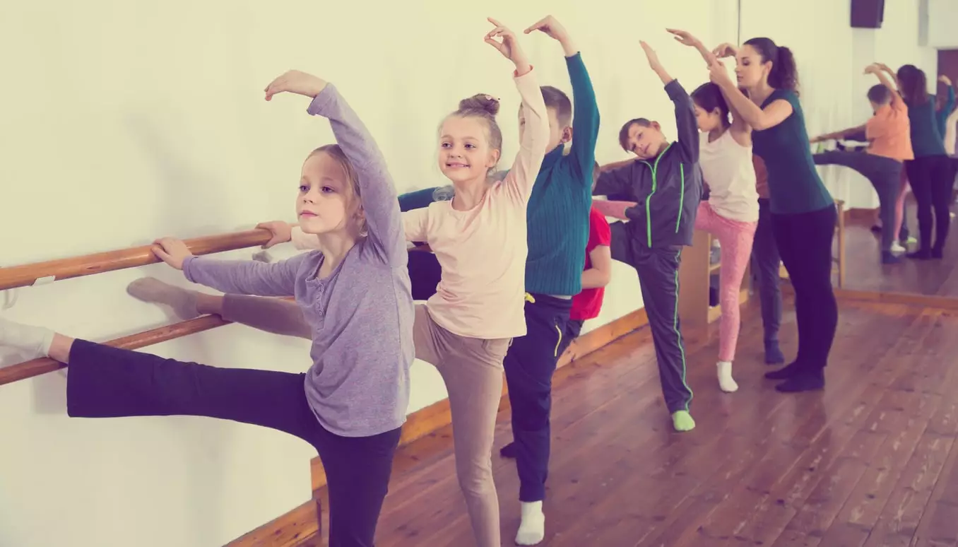 kids dancing together in classroom as a good exercise for kids diagnosed with Osgood-Schlatter Disease