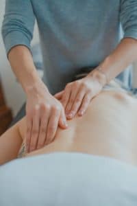 Massage therapist working on a patient's back