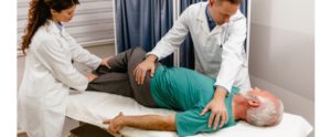 Senior man getting natural relief for sciatic pain with a physical therapist