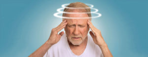 Man holding his head while experiencing vertigo