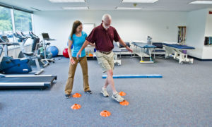 Physical therapist assisting patient with balance