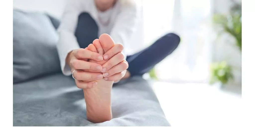 Senior woman holding her feet because of foot pain due to Morton’s Neuroma