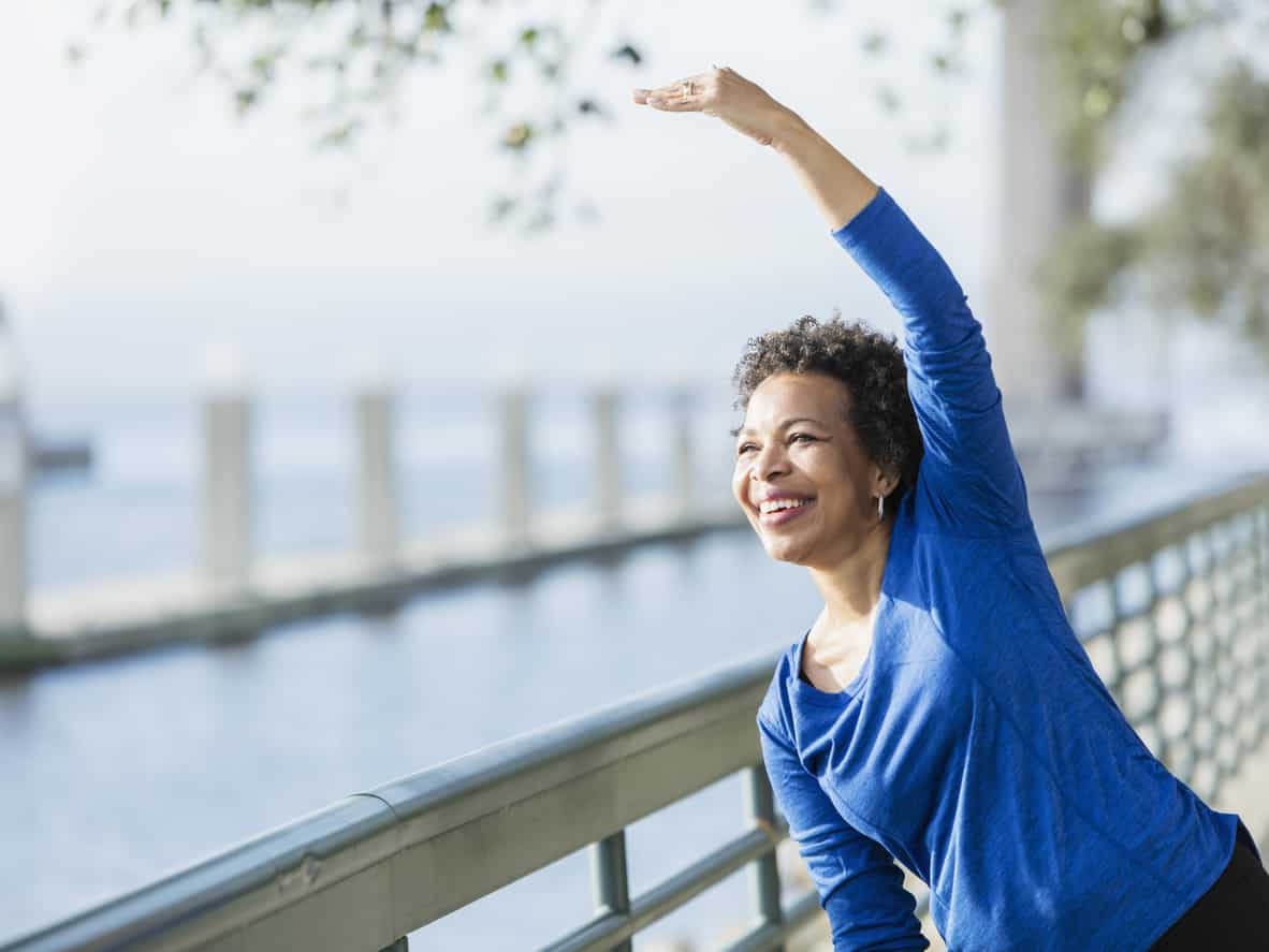 Person stretching by water | posture Cawley Physical Therapy and Rehab
