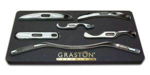 A close-up of several specially designed tools used in Graston Technique therapy