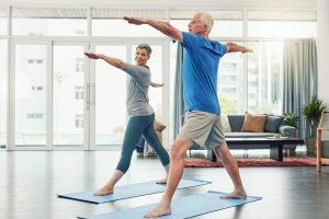 Active senior couple doing balance exercises