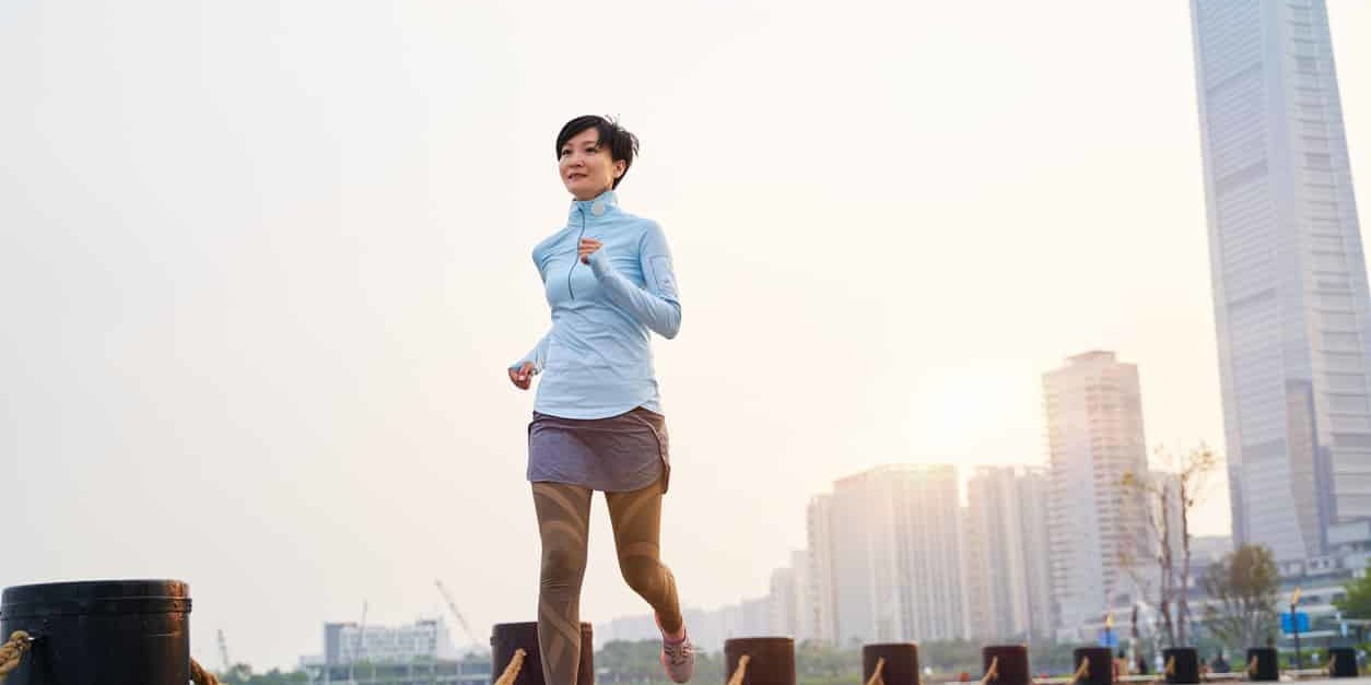Asian female runner during sunrise