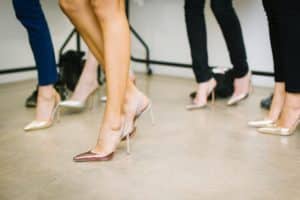 Multiple women wearing high heel shoes