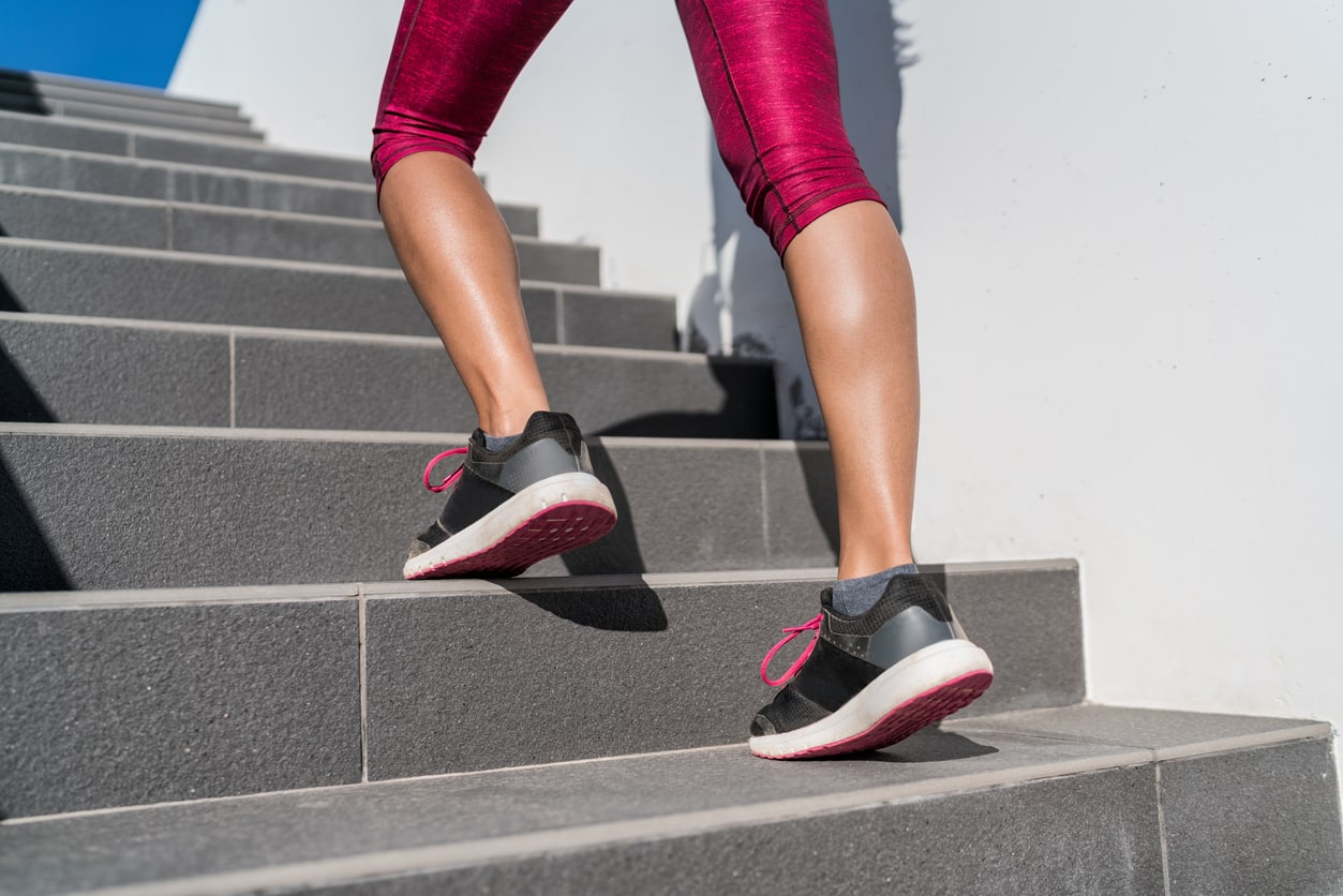 Woman working out in the stairs focusing on her calf muscles - preventing Achilles tendonitis injuries.